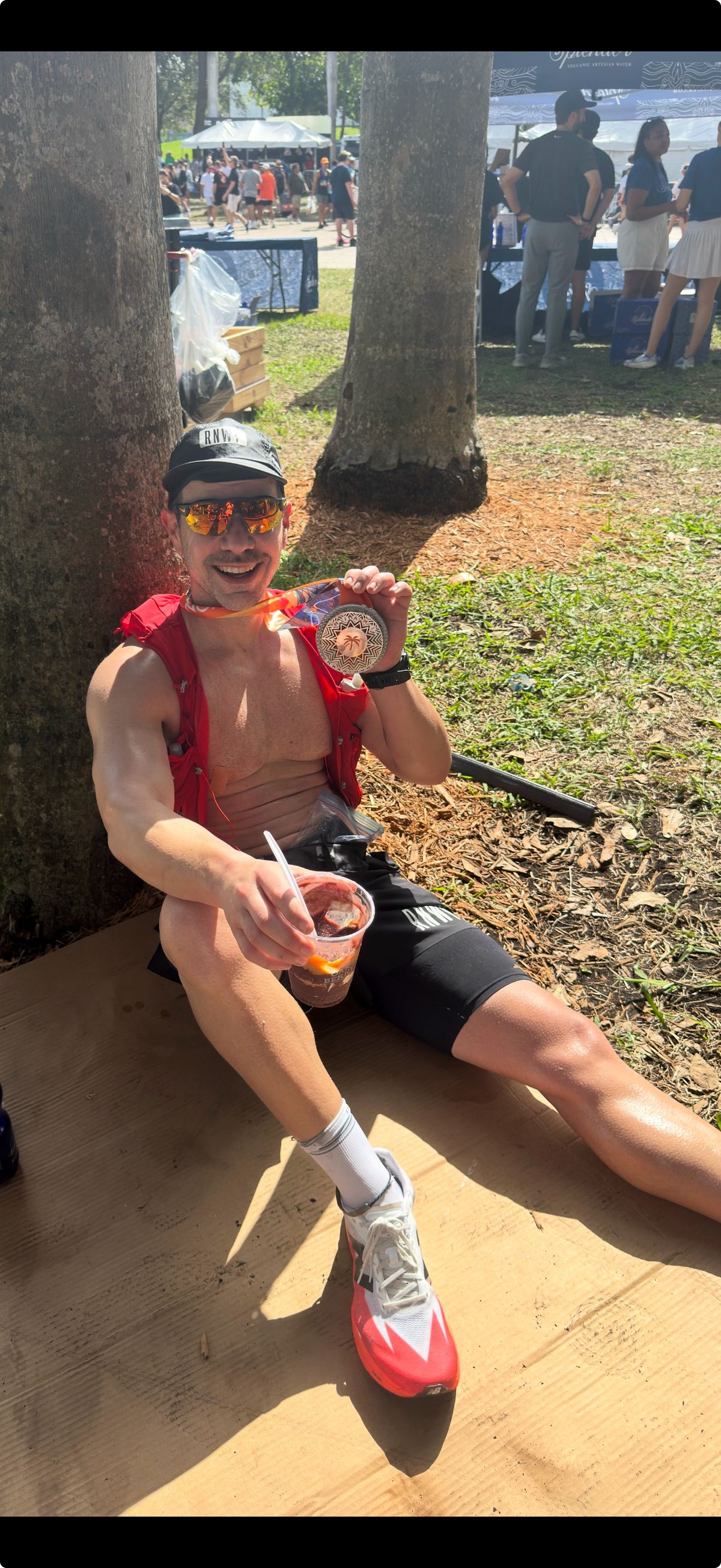 First-time marathon finisher resting after the Miami Marathon wearing race medal