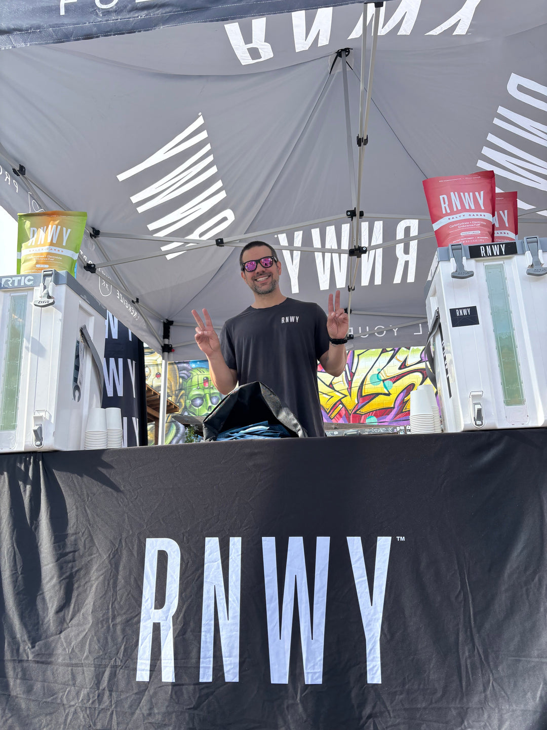 Dan Caron, co-founder of RNWY, testing products at a running event