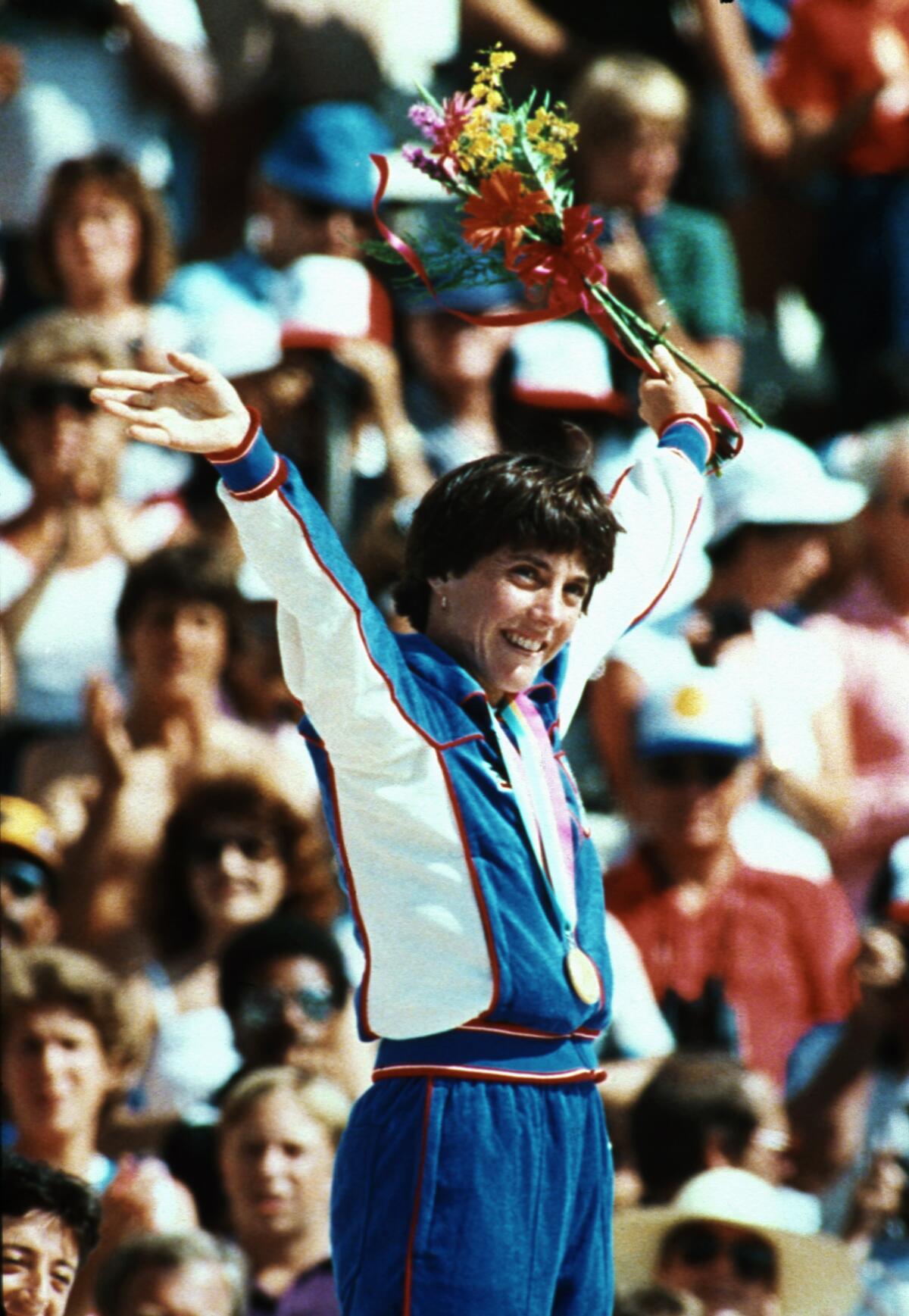 Joan Benoit Samuelson celebrates winning gold at the 1984 Los Angeles Olympics women's marathon.