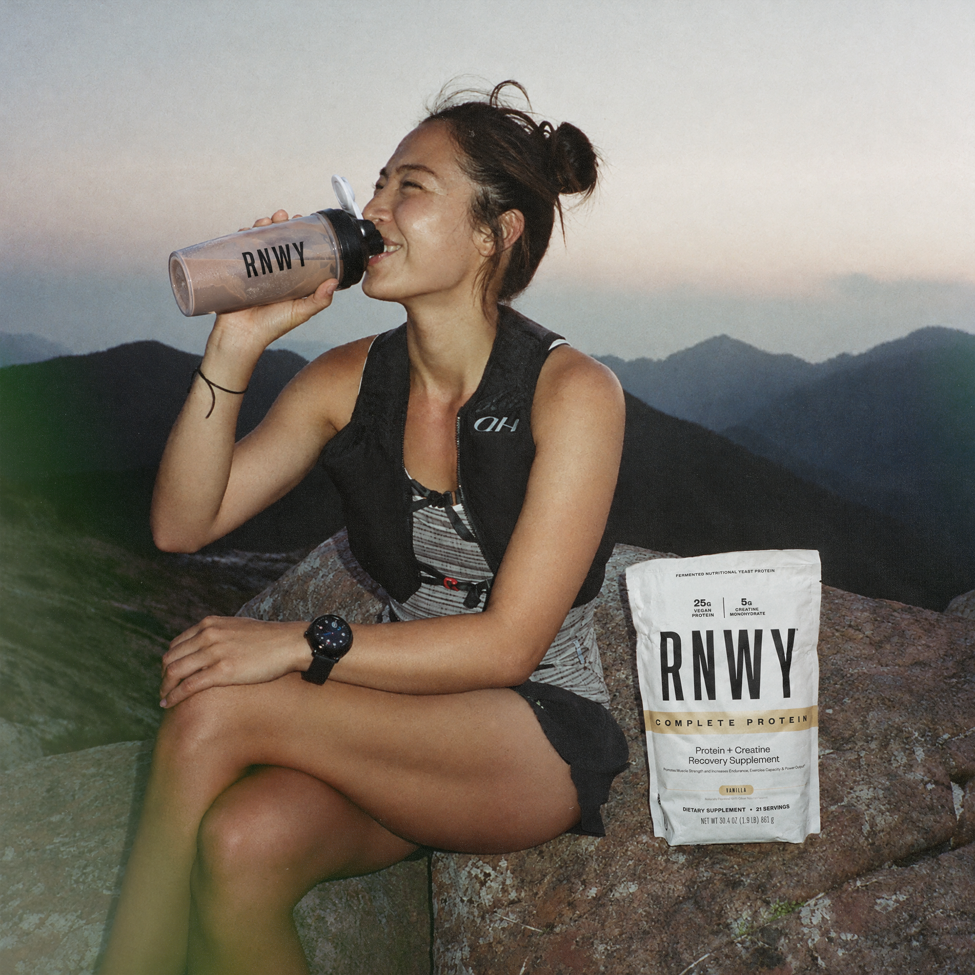 Athlete outdoors holding RNWY Complete Protein