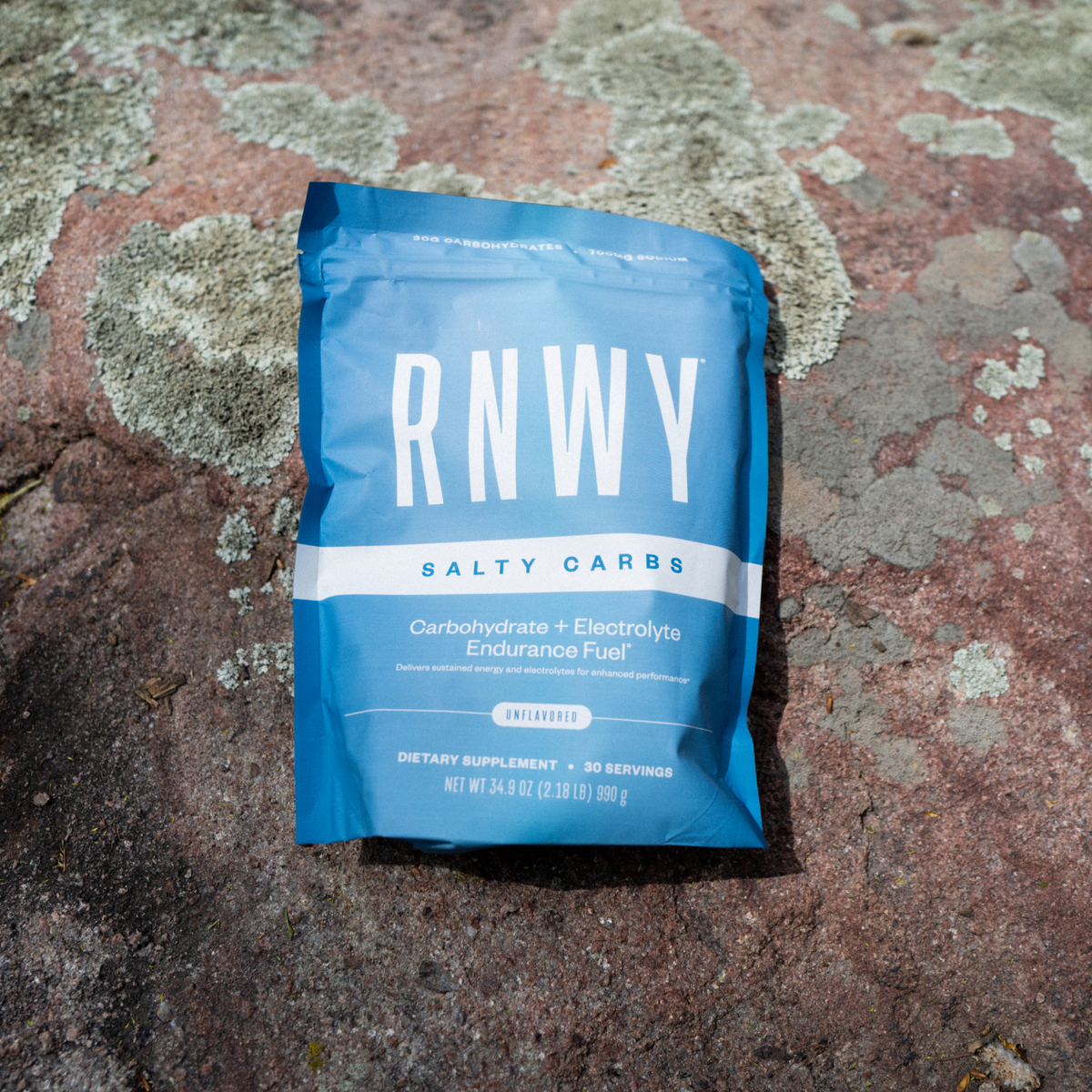 Blue package of RNWY Salty Carbs on a textured stone surface